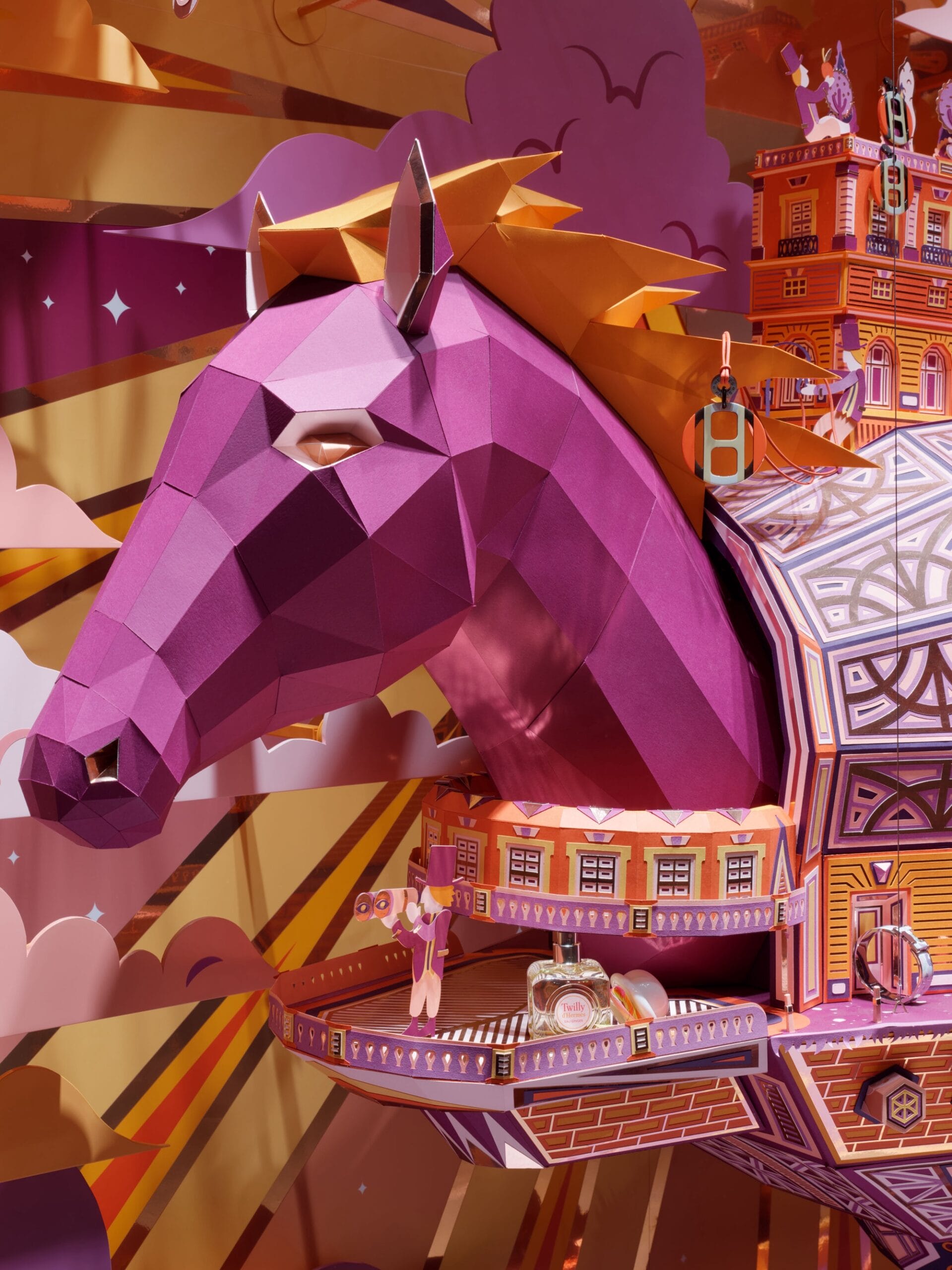 a pink paper horse with an orange mane attached to an intricately constructed paper ship. a small man in a top hat peers out from the balcony with binoculars 