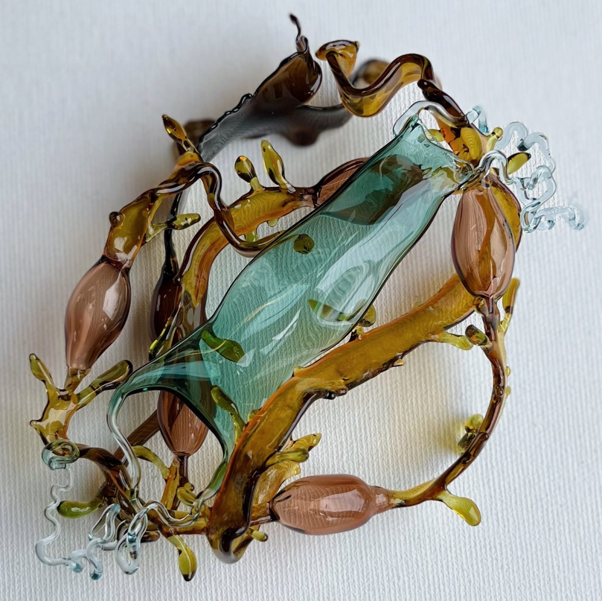 a glass sculpture depicting layers of kelp