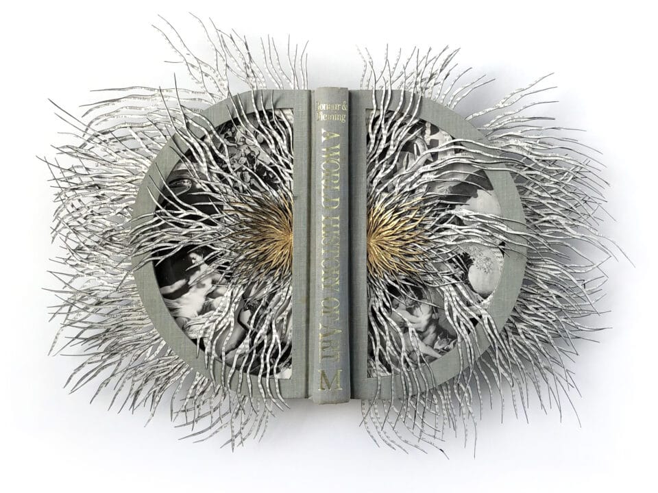 an altered hardcover book with its pages splayed outward and spliced into narrow, capillary-like slivers that have a symmetrical look. the spine of the book in the middle reads, "A World History of Art"